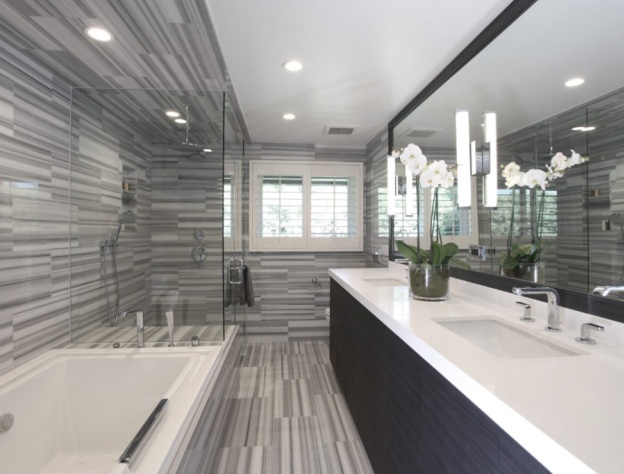 Lifestyle image of a grey bathroom design, featuring grey striped tiles across its floor and walls